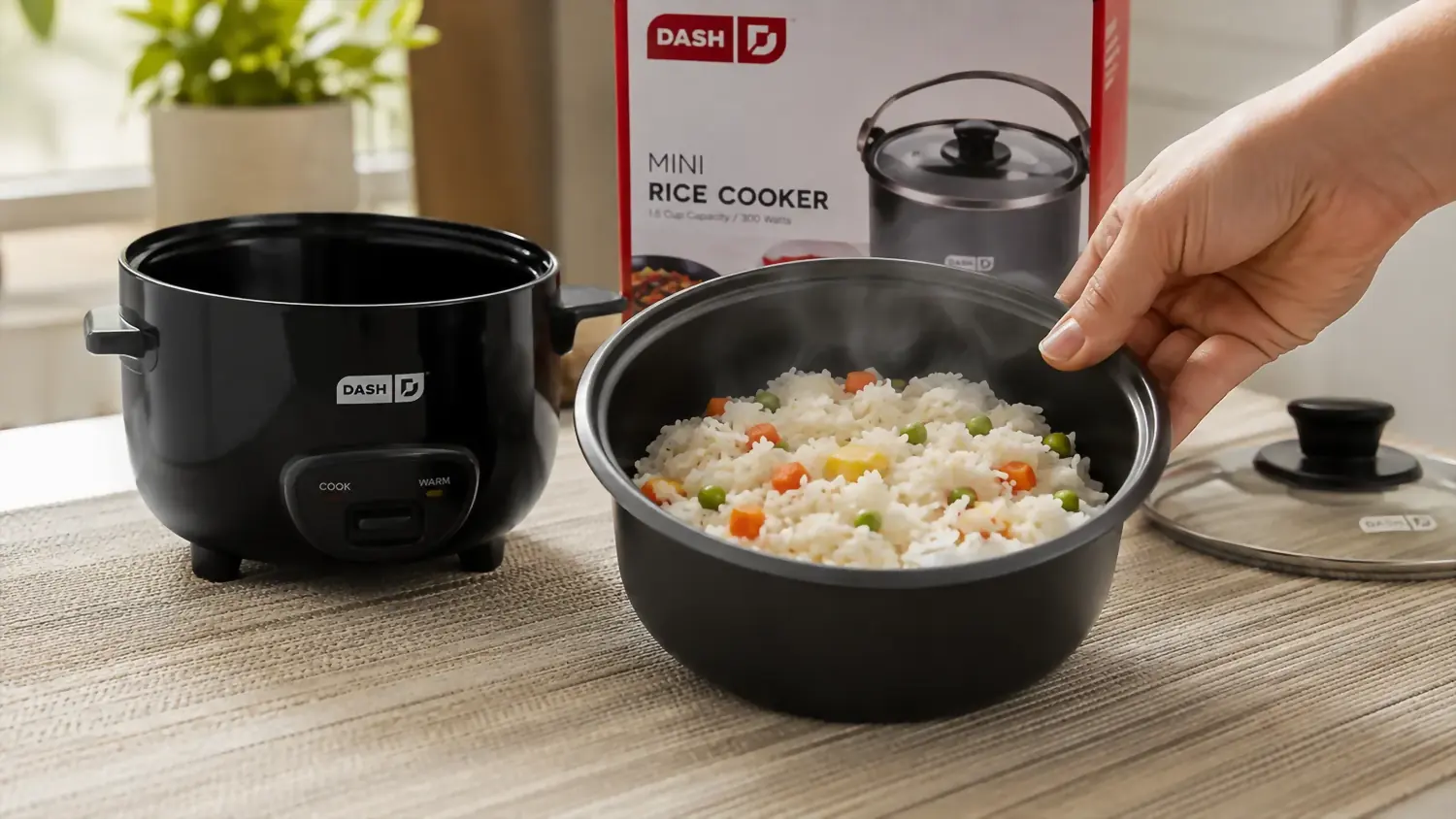 Hand lifting the ceramic nonstick pot out of the rice cooker to serve straight from it