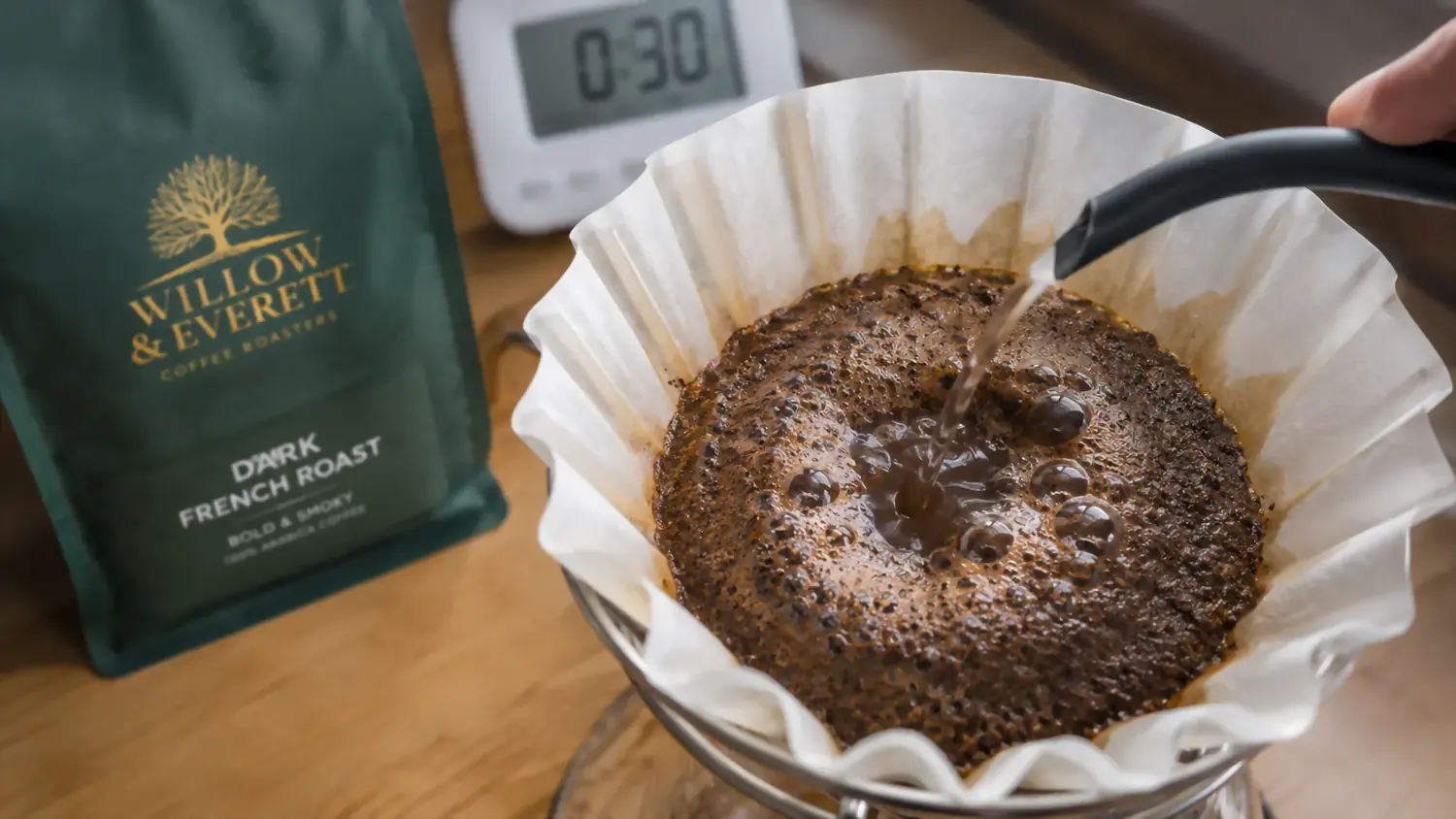 Coffee grounds bubbling and releasing gas during the bloom stage of pour-over brewing, just after the first small pour